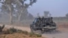 FILE - Members of the Cameroonian Rapid Intervention Force patrol on the outskirt of Mosogo in the far north region of the country where Boko Haram jihadist have been active since 2013, on March 21, 2019. 