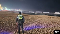 FILE - A South Korean Coast Guard member patrols a beach in Gangneung on January 1, 2024, as South Korea issued tsunami advisory after a major earthquake in Japan.