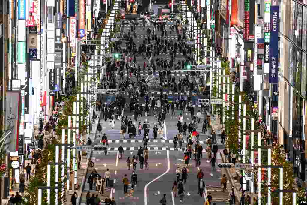 People walk on a street in Tokyo's Ginza area, Japan.