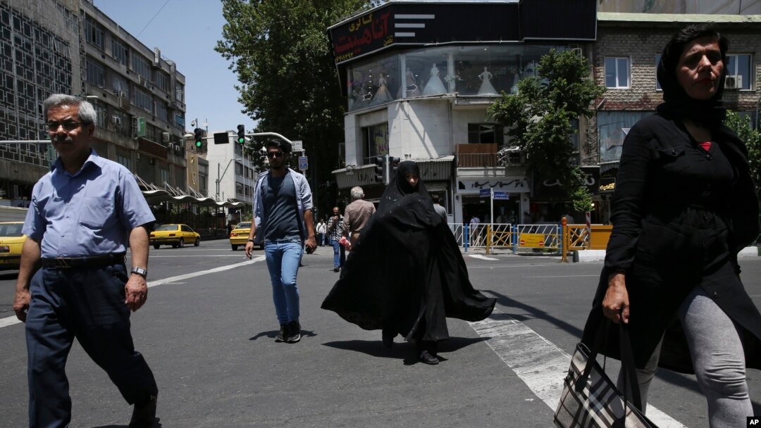 Iranian pedestrians cross Jomhouri-e-Eslami (Islamic Republic) St. in downtown Tehran, Iran, June 9, 2018.