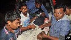 A man injured in an attack on a Shi'ite mosque is carried for treatment in Bogra district, Bangladesh, Nov. 26, 2015.