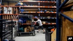 In this June 1, 2016 photo, a worker for MBS Equipment Co., a grip and lighting company, moves equipment in their warehouse at Second line Stages, in New Orleans. Louisiana’s once-booming film industry, branded as “Hollywood South”, has gone from darling to Hollywood castoff.