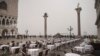 Empty tables sit in St. Mark&#39;s square in Venice, Italy. Italy has been scrambling to check the spread of Europe&#39;s first major outbreak of the new viral disease amid rapidly rising numbers of infections and calling off the popular Venice Carnival and closing tourist attractions.