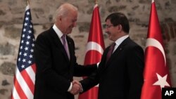 U.S. Vice President Joe Biden, left, and Turkish Prime Minister Ahmet Davutoglu shake hands before a meeting in Istanbul, Turkey, Nov. 21, 2014. 