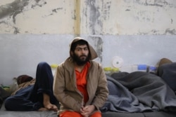 Thousands of foreign suspects who surrendered over a year ago as Islamic State lost its last territory are still being held with no formal charges or trials, Feb. 16, 2020, in Hasseka, Syria. (Heather Murdock/VOA)