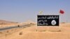 A general view taken on August 13, 2017 shows an Islamic State (IS) group poster in the central Syrian town of Al-Sukhnah. Pro-government fighters cleared the area after taking control of the county's large desert area called the Badiya.