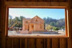 In this Nov. 4, 2019, photo, members of the Chandler family, father Joel and sons Bobbie and Dale, and their construction crew build a home in Calistoga, Calif.
