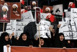 Lebanese protesters take part in a demonstration against the execution of prominent Shi'ite Muslim cleric Nimr al-Nimr (pictured on the posters) by Saudi authorities, in the southern Lebanese city of Nabatiyeh, Jan. 13, 2016.