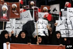 FILE - Lebanese protesters take part in a demonstration against the execution of prominent Shi'ite Muslim cleric Nimr al-Nimr (pictured on the posters) by Saudi authorities, in the southern Lebanese city of Nabatiyeh, January 13, 2016.