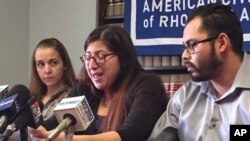 FILE - Lilian Calderon, center, cries as she describes her experiences while in custody, alongside her husband, Luis Gordillo, right, during a news conference at the office of the American Civil Liberties Union in Providence, R.I., Feb. 14, 2018. Calderon was detained by Immigration and Customs Enforcement after an interview designed to confirm her marital relationship.