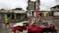 A man walks amid the debris of a destroyed car and buildings after the devastating earthquake in Pedernales, Ecuador, April 24, 2016