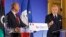 French Foreign Minister Laurent Fabius, right, addresses reporters during a joint press conference with his Libyan counterpart Mohamed Abdulaziz, left, at the end of a conference on Libya held at the foreign ministry in Paris, Feb. 12, 2013. 