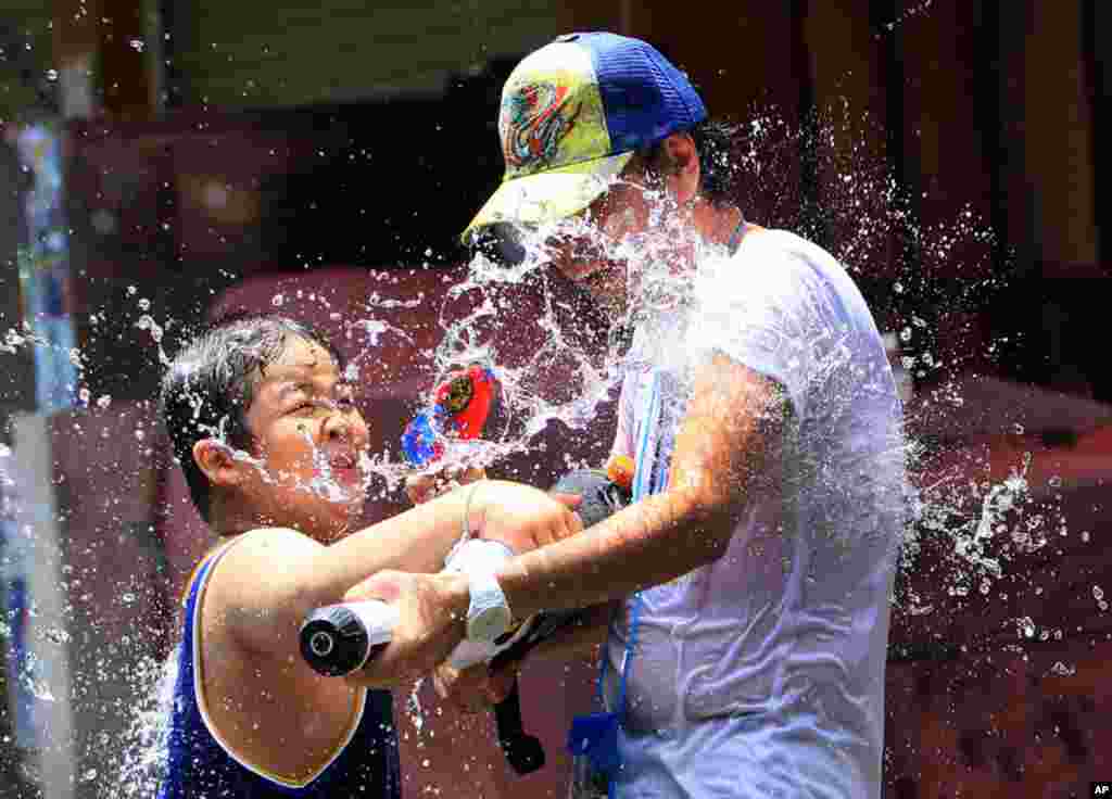 People celebrate the new year with water guns during Songkran, in Bangkok, Thailand, April 13, 2012. (AP)