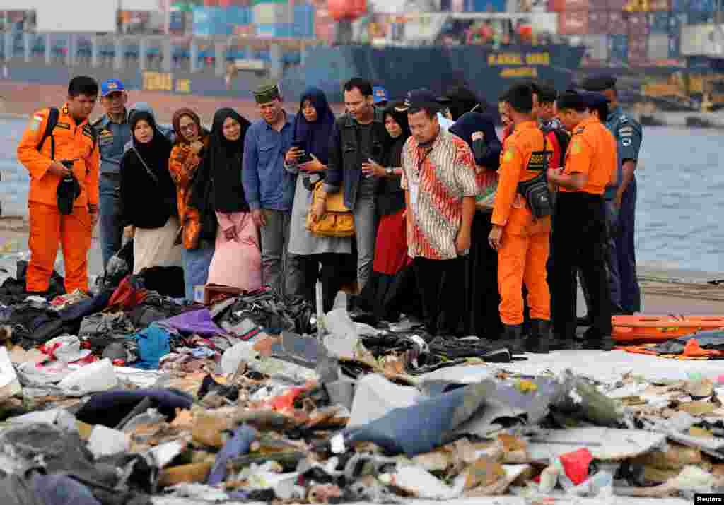 Families of the passengers of crashed Lion Air flight JT610 look at their belongings, at Tanjung Priok port in Jakarta, Indonesia.