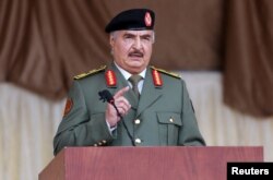 FILE - Libyan military commander Khalifa Haftar gestures as he speaks during Independence Day celebrations in Benghazi.