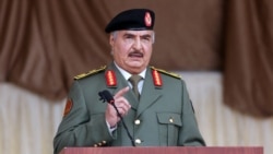 FILE PHOTO: Libyan military commander Khalifa Haftar gestures as he speaks during Independence Day celebrations in Benghazi