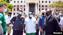 South African President Cyril Ramaphosa inspects damages after a fire broke out at the Parliament building in Cape Town, Jan. 2, 2022. (Elmond Jiyane/GCIS/Handout)