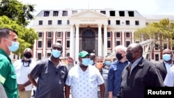 South African President Cyril Ramaphosa inspects damages after a fire broke out at the Parliament building in Cape Town, Jan. 2, 2022. (Elmond Jiyane/GCIS/Handout)