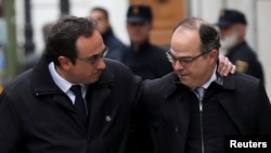 Catalan politicians Josep Rull (L) and Jordi Turull arrive together to the Supreme Court after being summoned and facing investigation for their part in Catalonia's bid for independence in Madrid, Spain, March 23, 2018. 