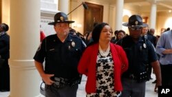 Sen. Nikema Williams (D-Atlanta) is arrested by capitol police during a protest over election ballot counts in the rotunda of the state capitol building Tuesday, Nov. 13, 2018, in Atlanta. 