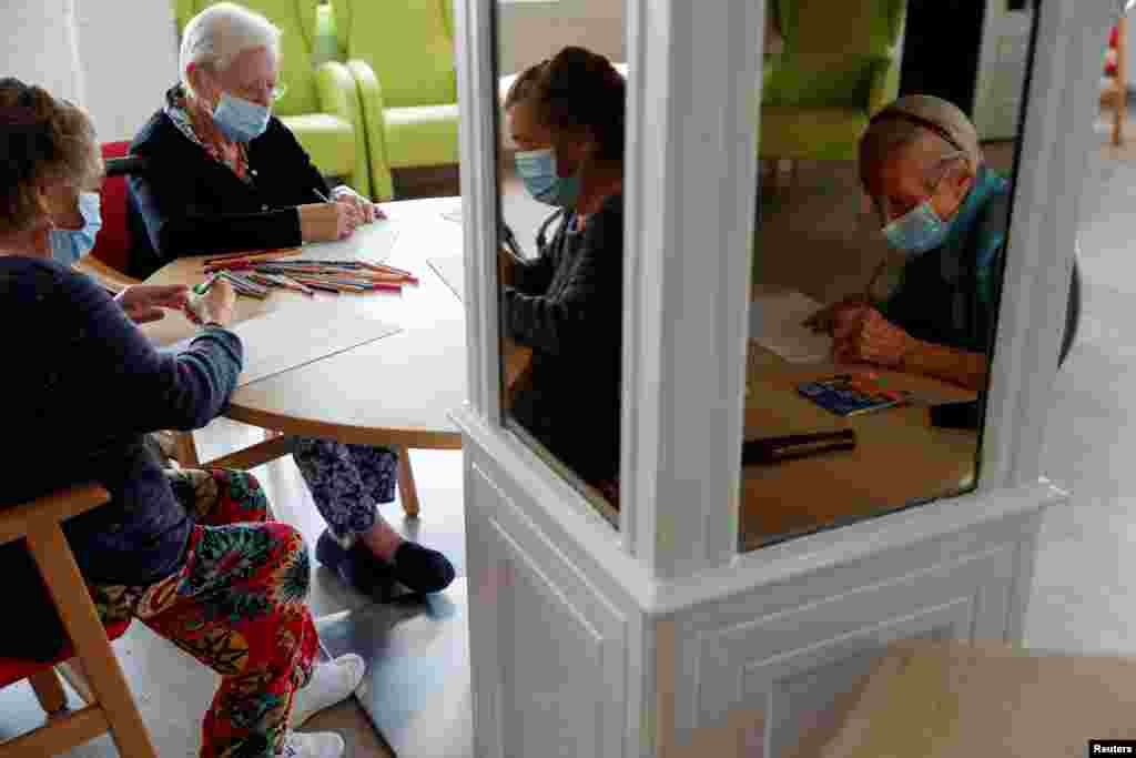 Residents take part in a drawing contest to mark International Day of Older Persons at Casaverde nursing home in Navalcarnero, Spain.