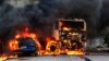 Vehicles burn in the street after attacks in the city of Fortaleza, northeastern Brazil, Jan. 3, 2019. 