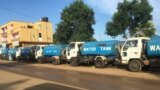 FILE - Trucks wait at a fuel station in South Sudan's capital of Juba, Oct. 1, 2017.