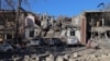 This photograph taken on Nov. 25, 2024 shows damaged cars in the courtyard of a destroyed building following a missile attack in Odesa.