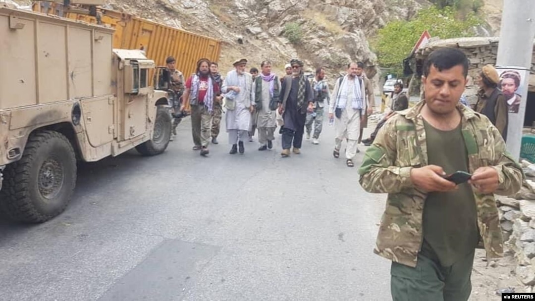 Anti-Taliban commanders walk on a road in Panjshir Valley, Afghanistan, Aug. 23, 2021. (Aamaj News Agency via Reuters)