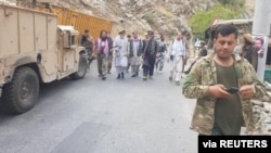 Anti-Taliban commanders walk on a road in Panjshir Valley, Afghanistan, Aug. 23, 2021. (Aamaj News Agency via Reuters)