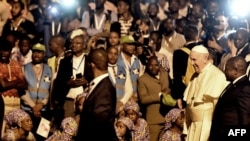 Pope Francis attends a welcome ceremony flanked by Mozambique President Filipe Nyusi upon his arrival at the Maputo International Airport in Maputo, Mozambique, Sept. 4, 2019.