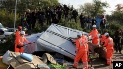 Crews start to demolish shelters in the makeshift migrant camp known as "the jungle" near Calais, northern France, Oct. 25, 2016. 