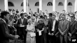 President John F. Kennedy gives a personal farewell message to Peace Corps volunteers in the White House Rose Garden August 28, 1961, before their departure the following day for assignments in Africa