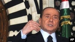 Italian Prime Minister Silvio Berlusconi gestures during a press conference, April 4, 2011