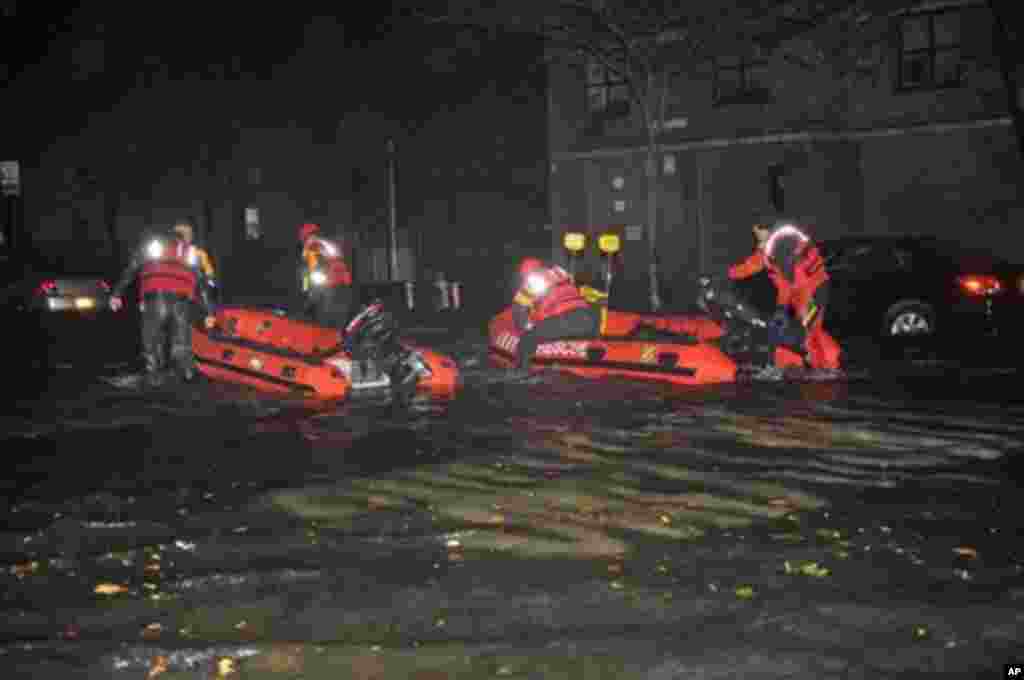 FDNY inflatable boats travel along 14th street towards the East River on a rescue mission in the wake of Hurricane Sandy, October 29, 2012, in New York. 