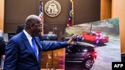 Fulton County District Attorney Paul Howard shows a picture of the incident in a courtroom as he announces 11 charges against former Atlanta Police Officer Garrett Rolfe, in Atlanta, Georgia, June 17, 2020.