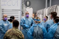 FILE - U.S. Army Major Sean Shirley holds a meeting with staff in the Javits New York Medical Station intensive care unit bay monitoring coronavirus disease (COVID-19) patients in New York City, April 4, 2020.