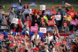 FILE - Supporters of President Donald Trump cheer during a campaign rally at MBS International Airport in Freeland, Mich., Sept. 10, 2020.