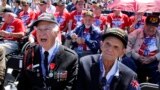World War II D-Day invasion veterans Herman Zeitchik (L) and Antonio Gimenez (R) are surrounded by other veterans as they attend a ceremony at the National World War II Memorial on the 70th anniversary of the D-Day invasion of Europe, while in Washington, D.C.