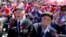 World War II D-Day invasion veterans Herman Zeitchik (L) and Antonio Gimenez (R) are surrounded by other veterans as they attend a ceremony at the National World War II Memorial on the 70th anniversary of the D-Day invasion of Europe, while in Washington, D.C.