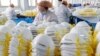 This photo taken on February 28, 2020 shows workers producing face masks at a factory in Handan in China's northern Hebei province.