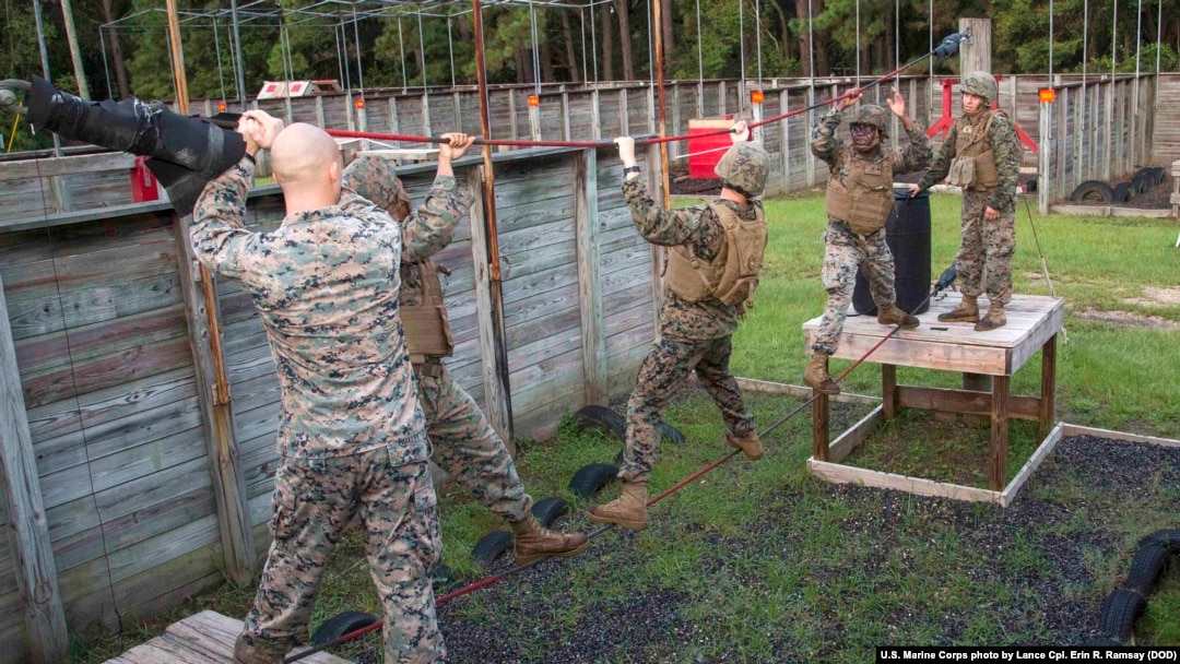 U.S. Marines from Marine Wing Support Detachment (MWSD) 31, climb across a rope during the Leadership Reaction Course on Marine Corps Recruit Depot Parris Island, South Carolina, Aug. 12, 2017. 