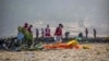 FILE - Rescuers work at the scene of an Ethiopian Airlines Boeing MAX crash on March 11, 2019, near Bishoftu, or Debre Zeit, Ethiopia.