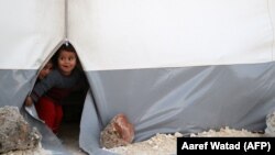 Syrian children play at a camp for displaced people in Bab al-Hawa, Idlib, April 22, 2018. (Aaref Watad/AFP)