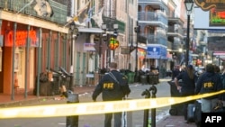 FBI investigators arrive at the scene where a white Ford F-150 pickup truck crashed after allegedly being driven into a crowd of New Year's revelers in the French Quarter of New Orleans, Louisiana, Jan. 1, 2025.