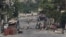 Armed gang members walk through the streets near the presidential palace as a transition council meant to usher in a new government, is set to be sworn in at the palace, though a date has yet to be confirmed, in Port-au-Prince, Haiti April 23, 2024. 