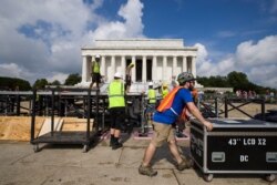 The stage is dismantled as clean up is underway after the Fourth of July celebrations in front of the Lincoln Memorial, Friday, July 5, 2019, in Washington.