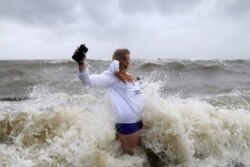 Audrey Ulfers stands on the shore of Lake Pontchartrain during Hurricane Barry in Mandeville, La., July 13, 2019.