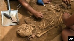 Archeologists excavating an ancient Phillstine cemetery near Ashkelon, Israel, June 28, 2016.