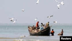 FILE - Fishermen catch fish at the shores of Bay of Bengal at Dublar Char in the Sundarbans, Bangladesh.